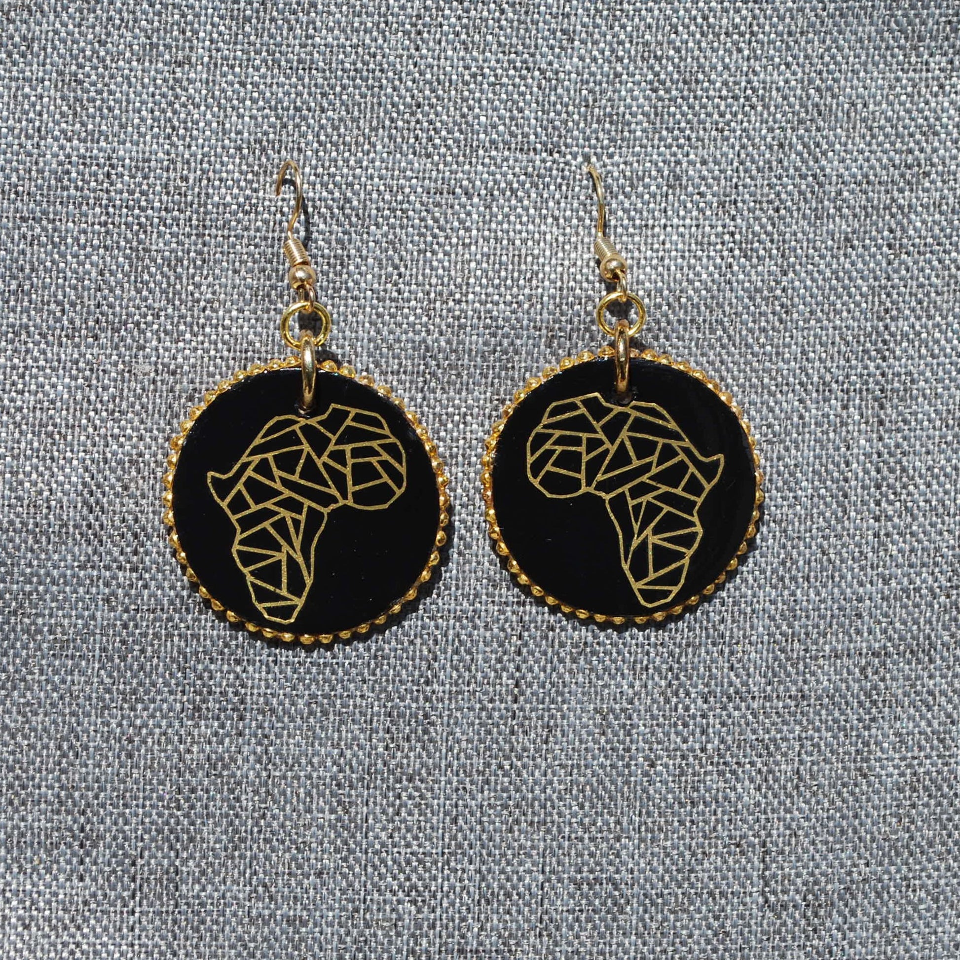 1.5" diameter earring round. Black earring with gold Africa applique. Gold rhinestones on edges. Gold colored metal hooks.