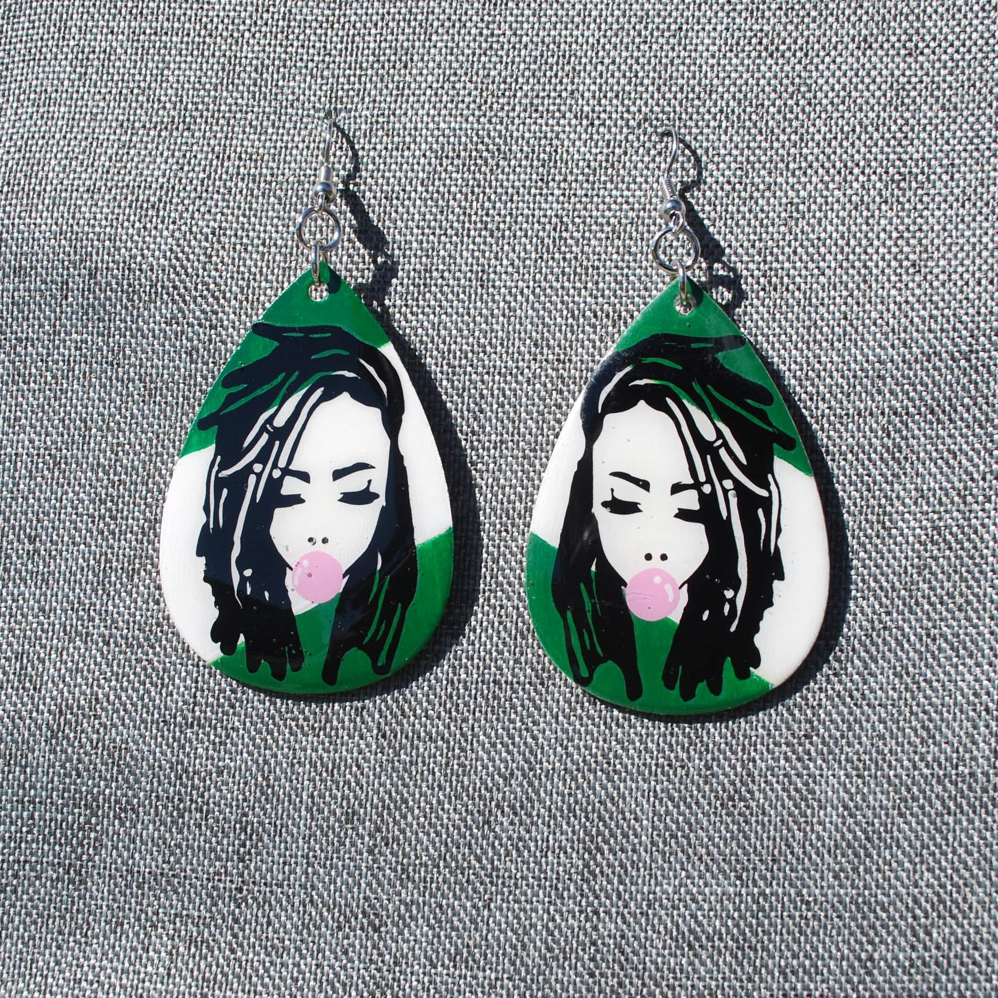 Green and white teardrop shaped earring.  Length 2". Loc'd woman with bubble gum applique.