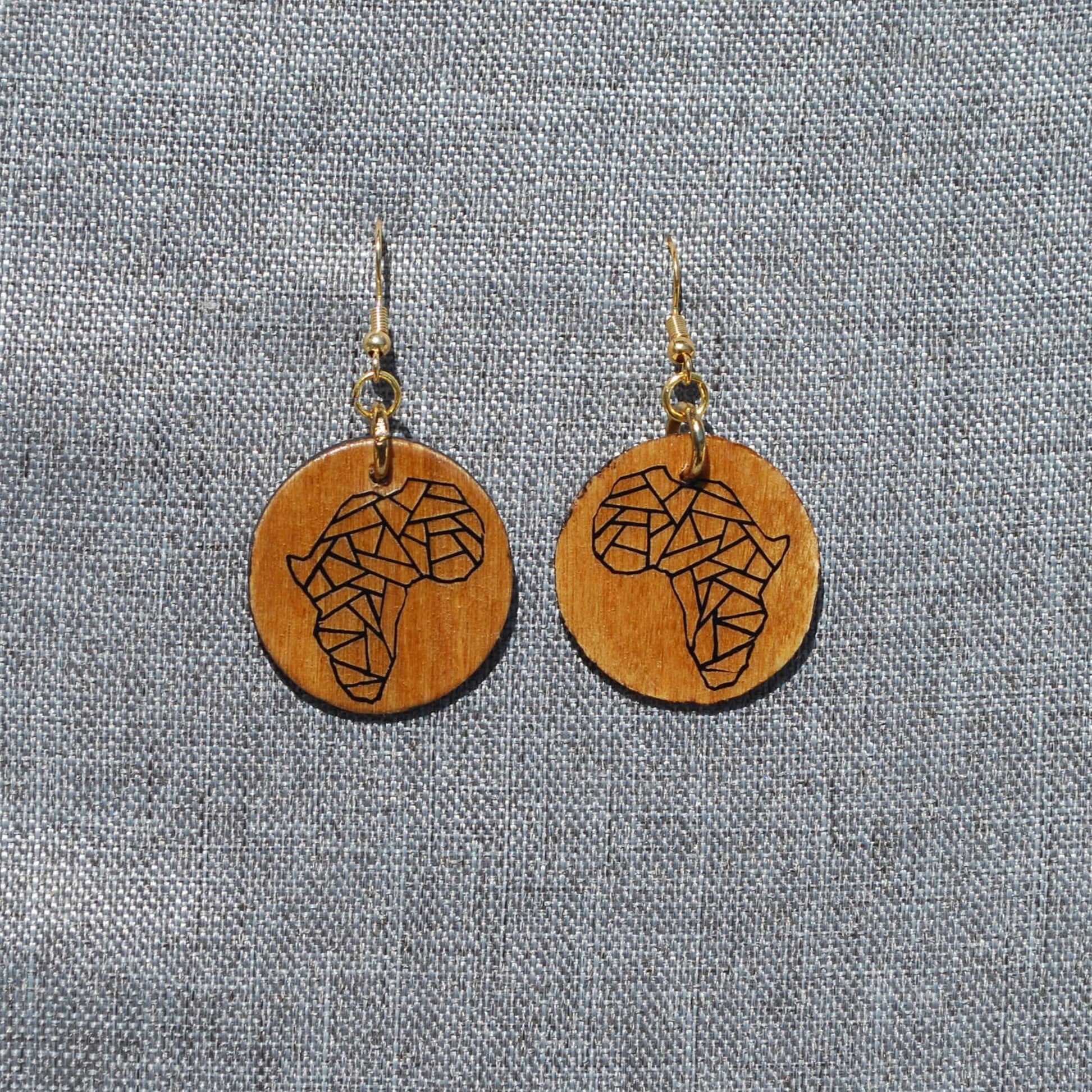 1.5" diameter round varnished wood earring with Africa applique. Nickel free gold colored metal hooks. 