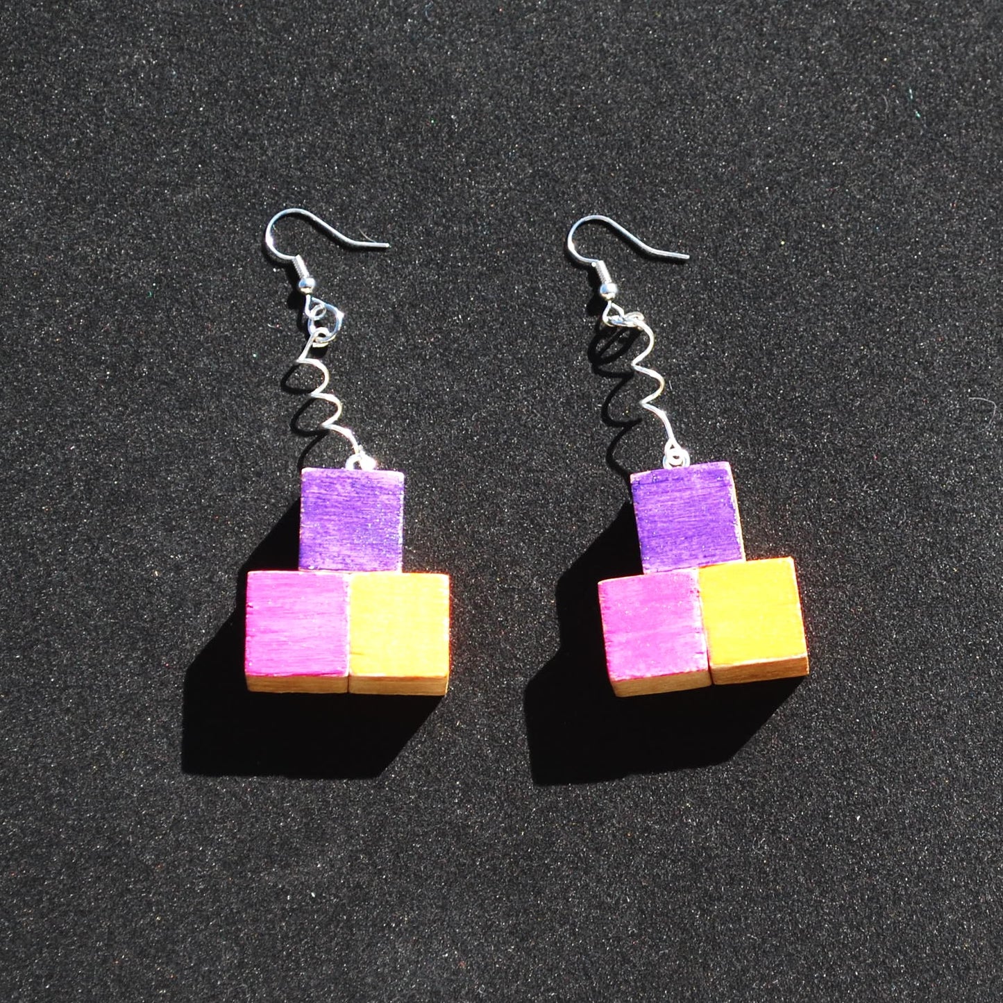 Purple, Pink, and Orange earring. Spiraled metal connector. Total length 2.5". Silver colored metal hooks and connector.