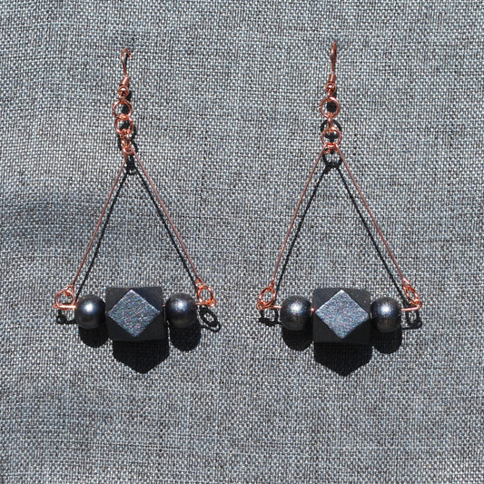 Dark gray painted wood and rose gold colored metal triangle earrings. Dark gray hand painted beads at bottom of triangle. Length 3".