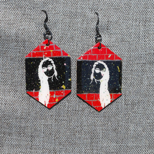 Black, red, and white hexagon earring. Brick and black background with braided woman white applique. Gunmetal hooks.